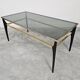 Mid Century Modern coffee table with gold-plated metal and smoked glass.