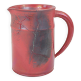 Red glazed ceramic jug with relief