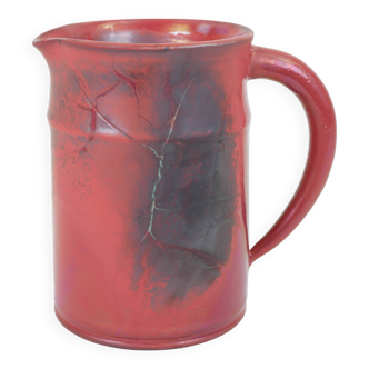 Red glazed ceramic jug with relief