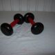 Red wooden and cast-iron dumbbells
