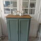 Vintage shoe cabinet smoked green wax finish, wooden top.