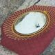 Vintage 1950s sun mirror in gold metal.