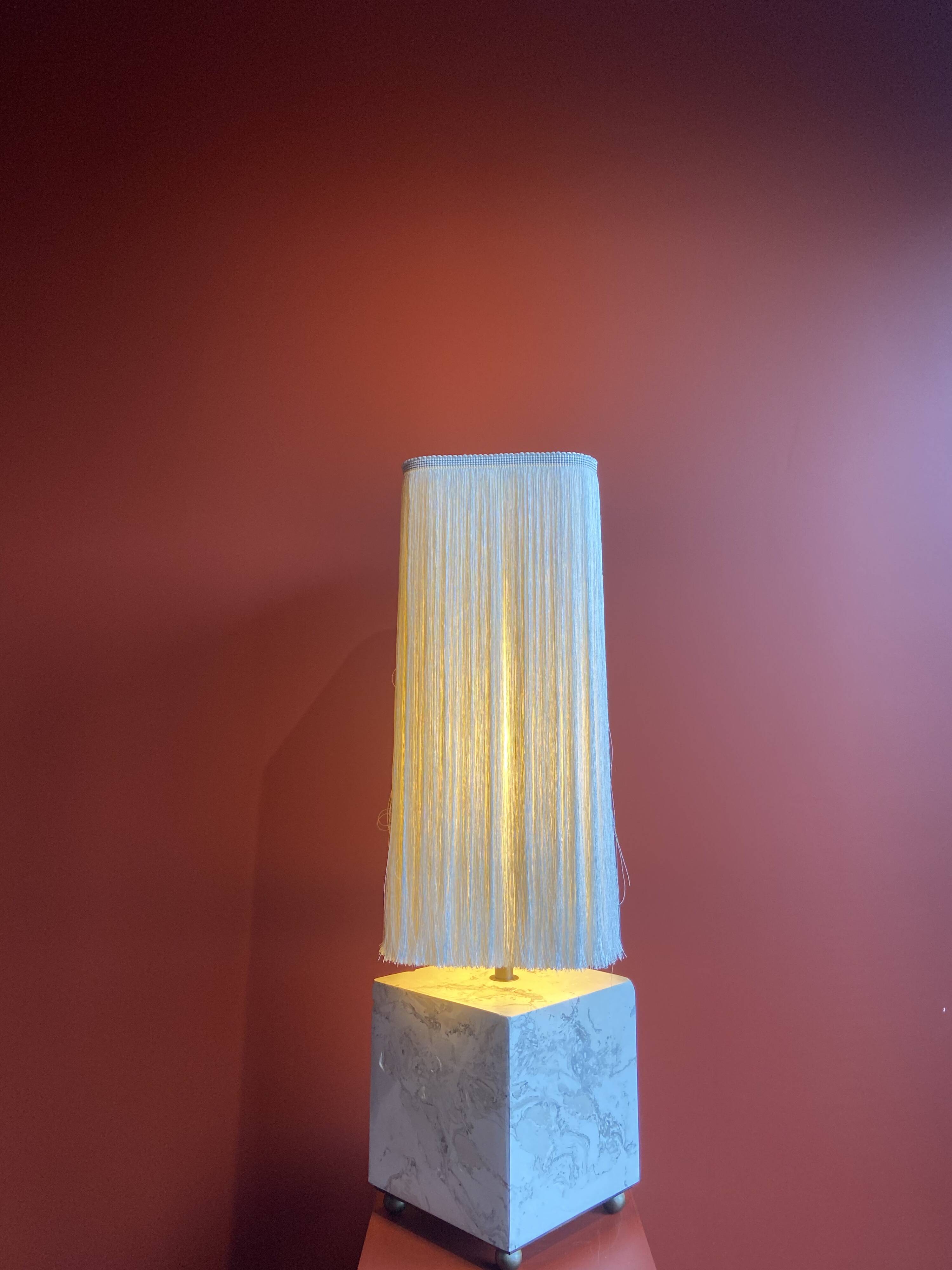 Beige marble stucco base, Houles white ecru fringed lampshade.
