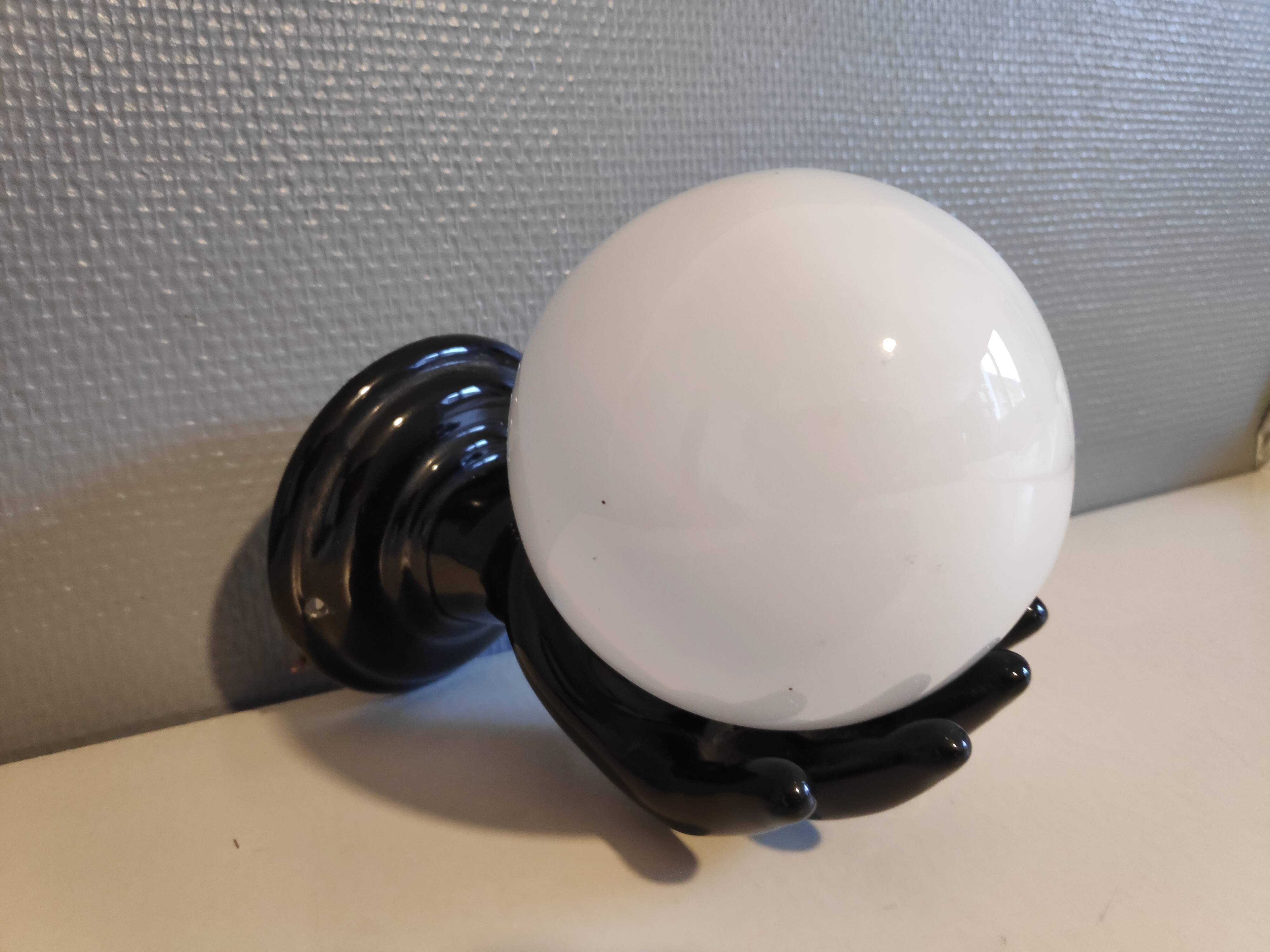 Black ceramic handand white opaline ball sconce