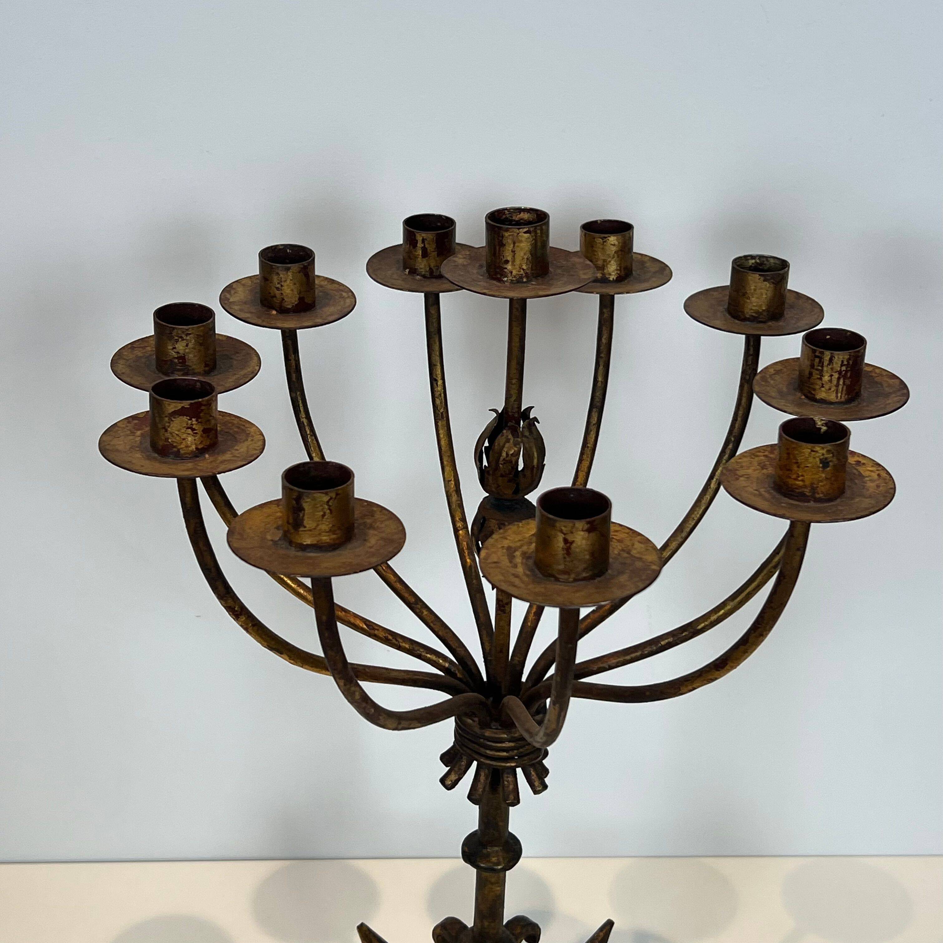 Important gilded wrought iron candelabrum with 11 arms.