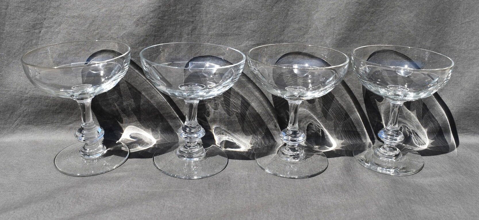9 old champagne glasses in flat-waisted blown glass