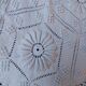 White bed throw with relief embroidery and floral patterns