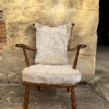 Scandinavian armchair in solid wood with beige fur cushion