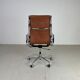 Fauteuil en cuir brun haut dossier soft pad group Eames ICF pour Herman Miller