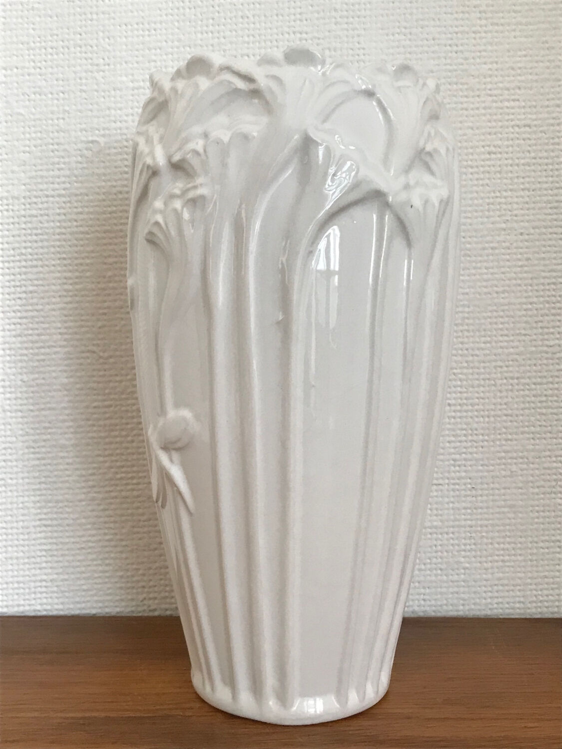Old white art nouveau vase with flowers and dragonflies