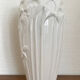 Old white art nouveau vase with flowers and dragonflies