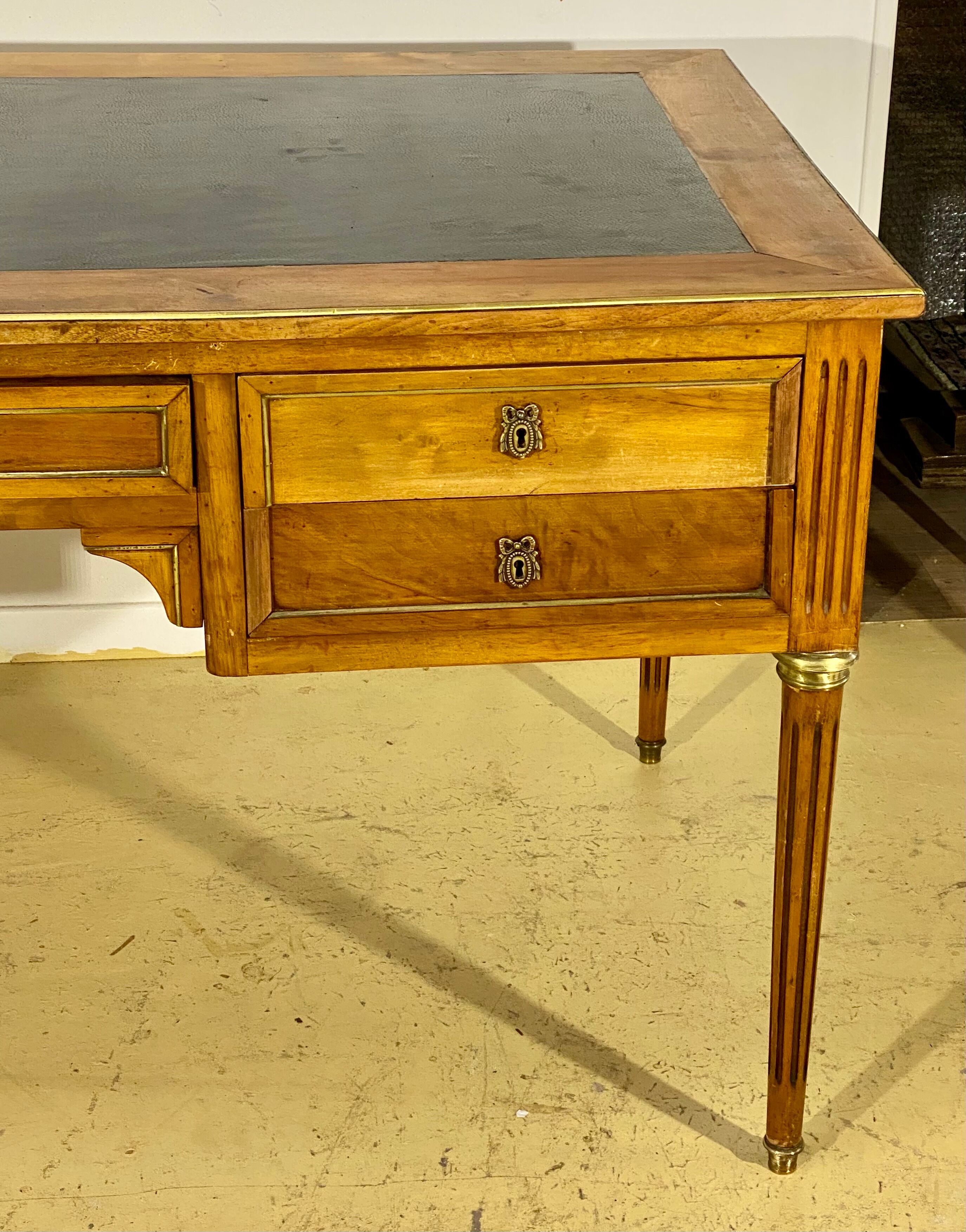 Louis XVI style desk in walnut veneer and brass fillets