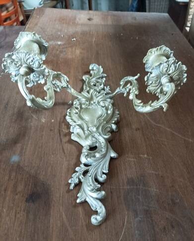 Cast iron wall candle holder with patinated gold metal