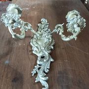 Cast iron wall candle holder with patinated gold metal