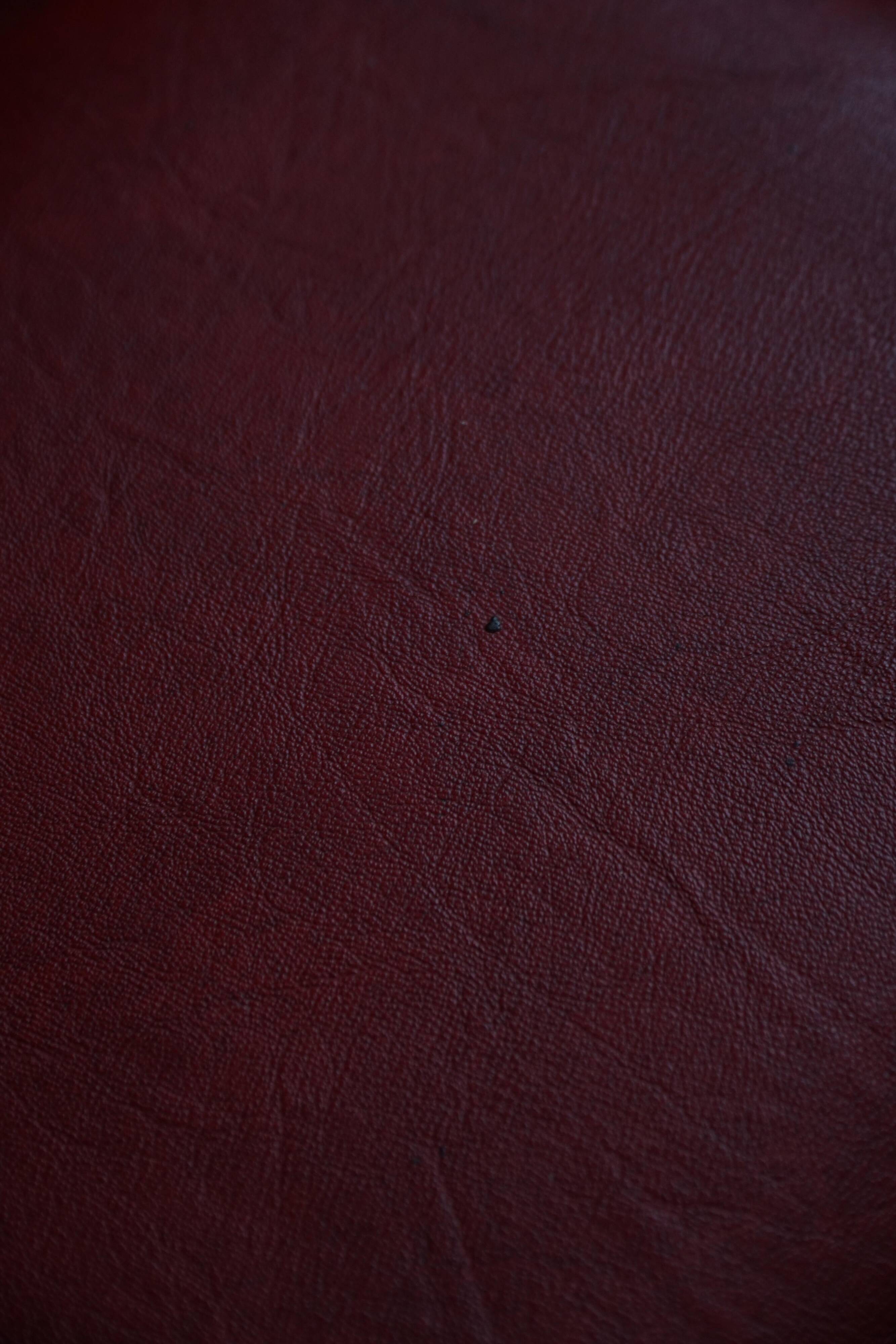 Danish sculpted oak stool from the mid-20th century with a red leather seat, 1950s.