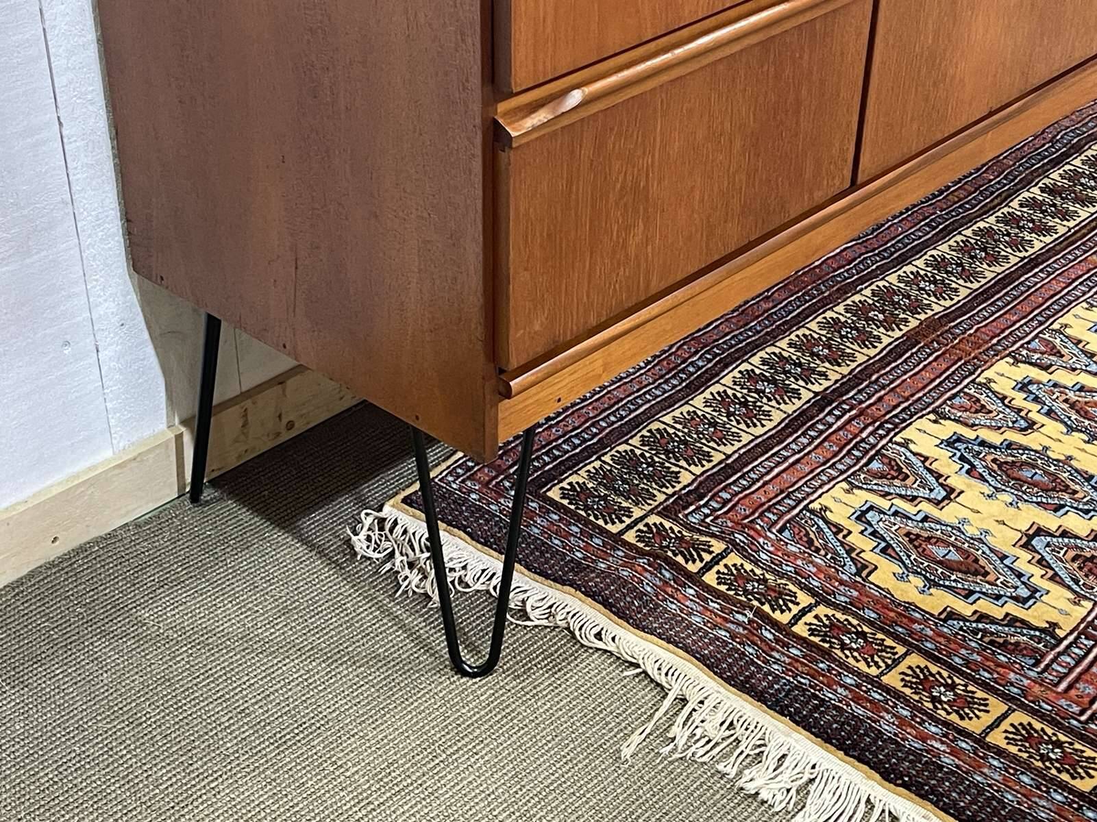 1970s English enfilade in teak with splayed legs.