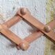 Wall-mounted accordion coat rack in solid pine