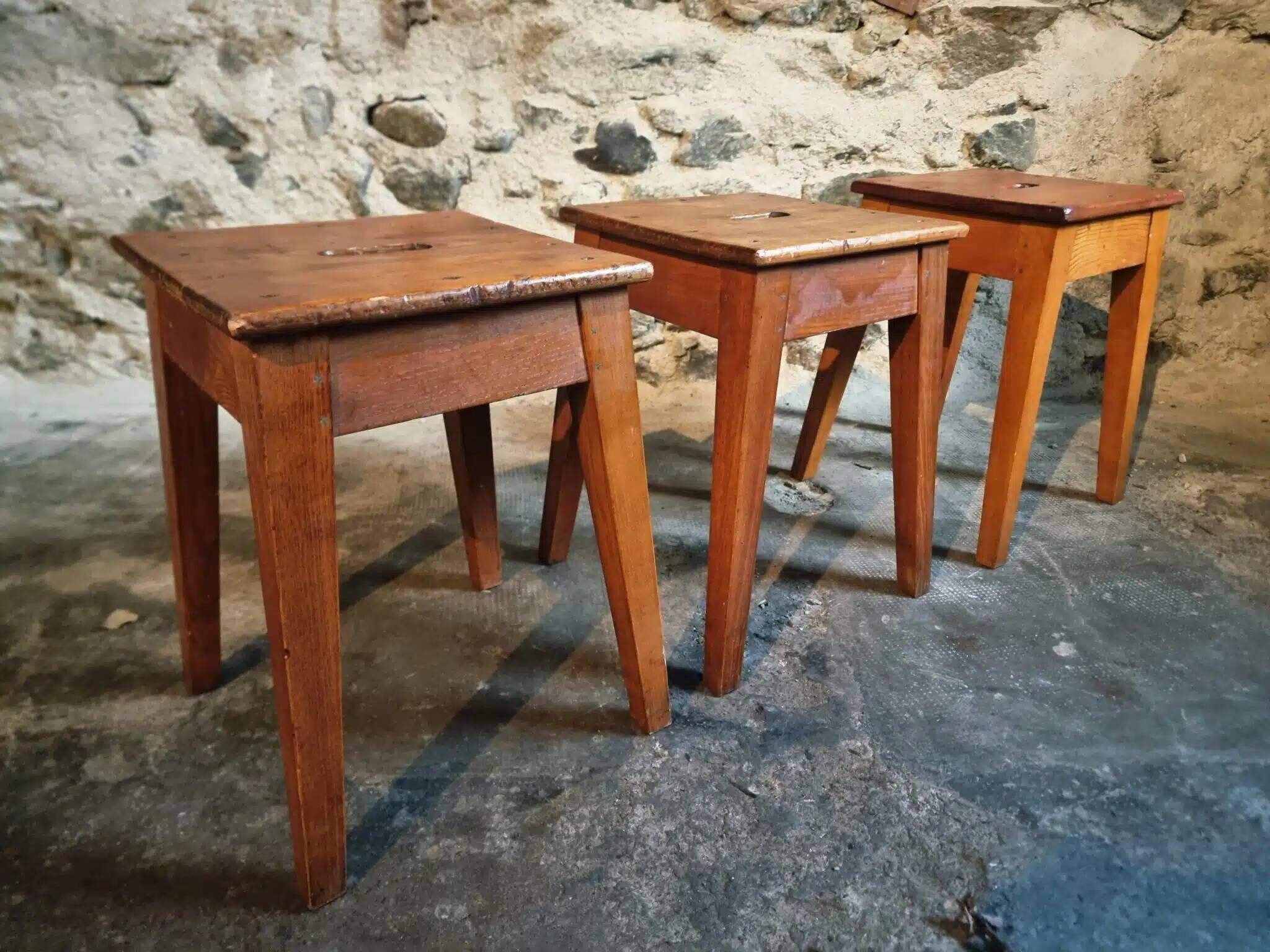 Set of 3 vintage French wooden stools from the 1950s.