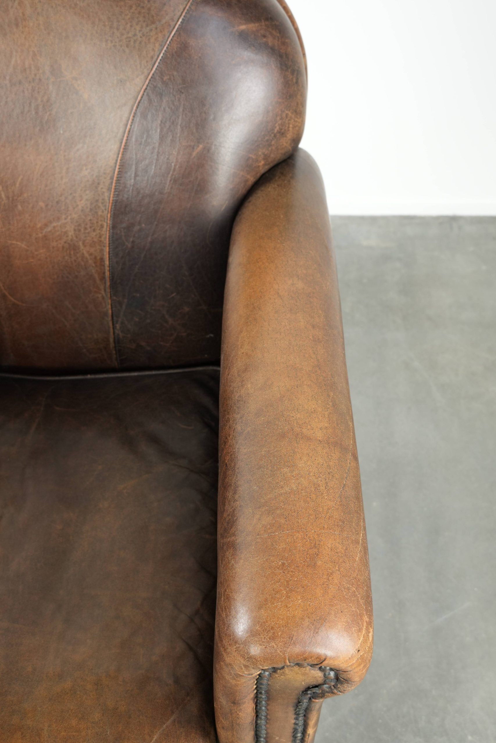 Armchair / lounge chair made of sheepskin leather with characterful patina