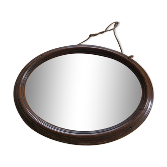 Old oval mirror with wooden frame