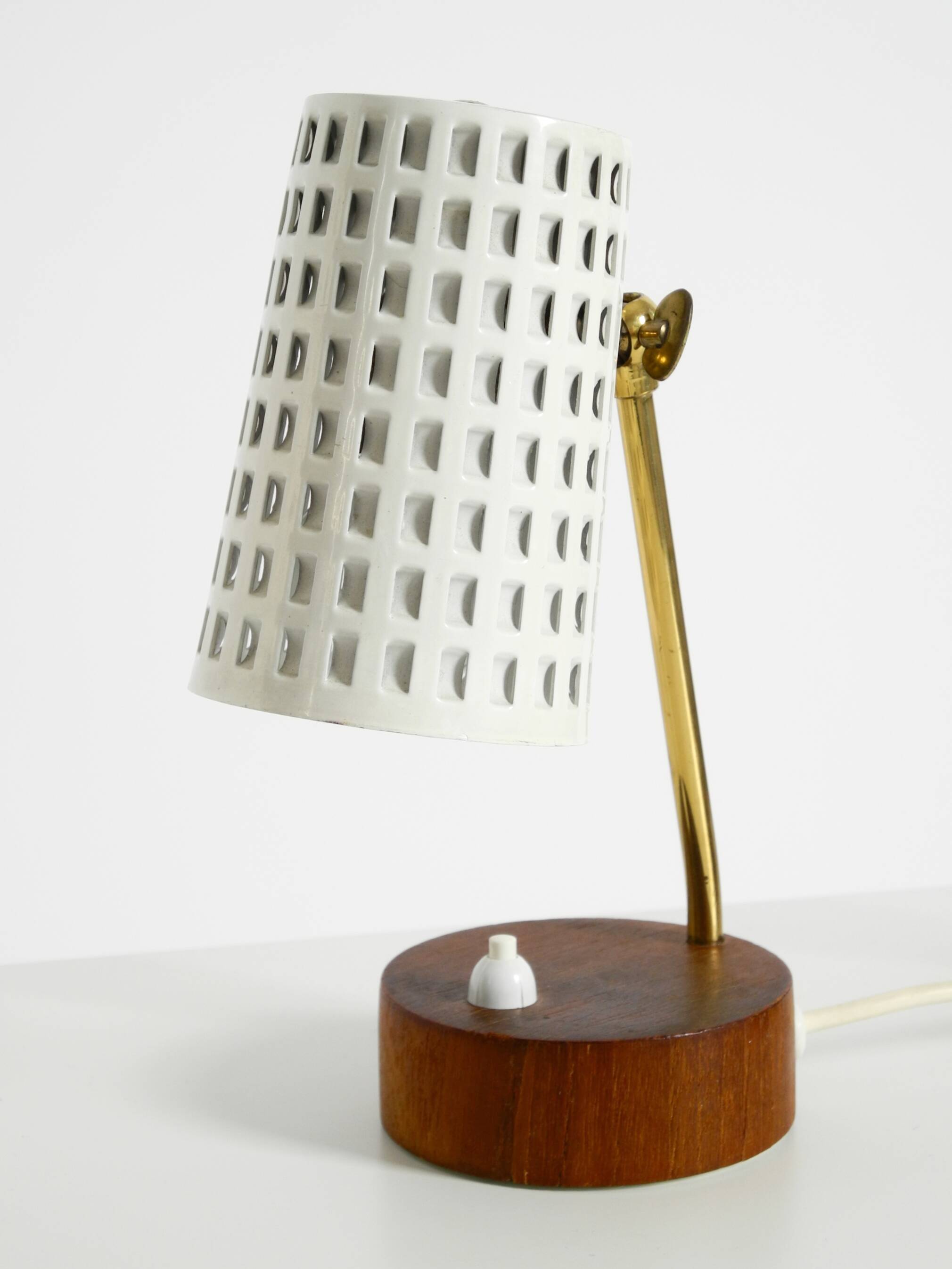 A pair of mid-century modern bedside lamps with perforated metal shades