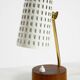 A pair of mid-century modern bedside lamps with perforated metal shades