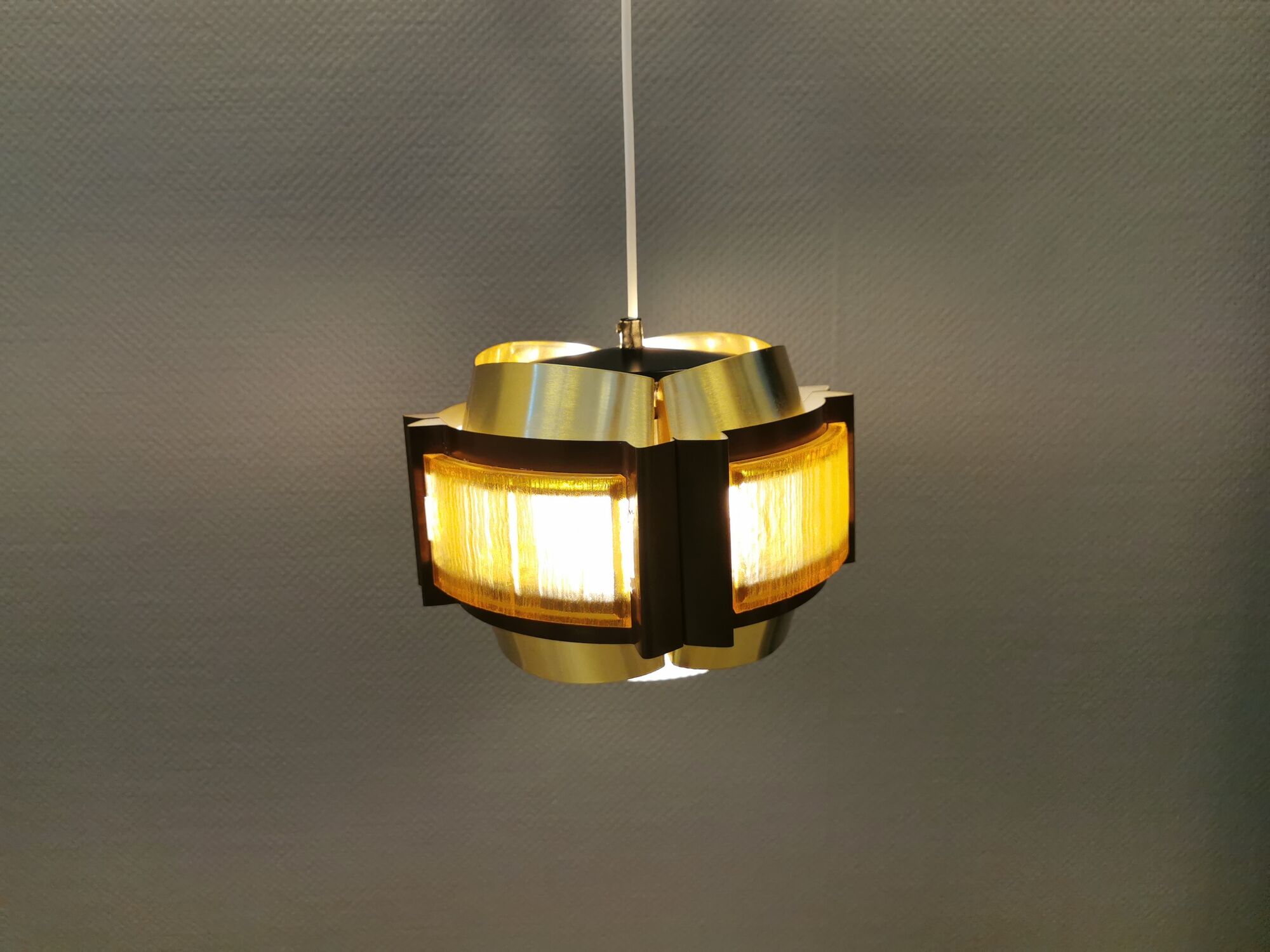 Danish hanging lamp, made in brass colored and brown metal, with yellowish hard pressed plastic deta