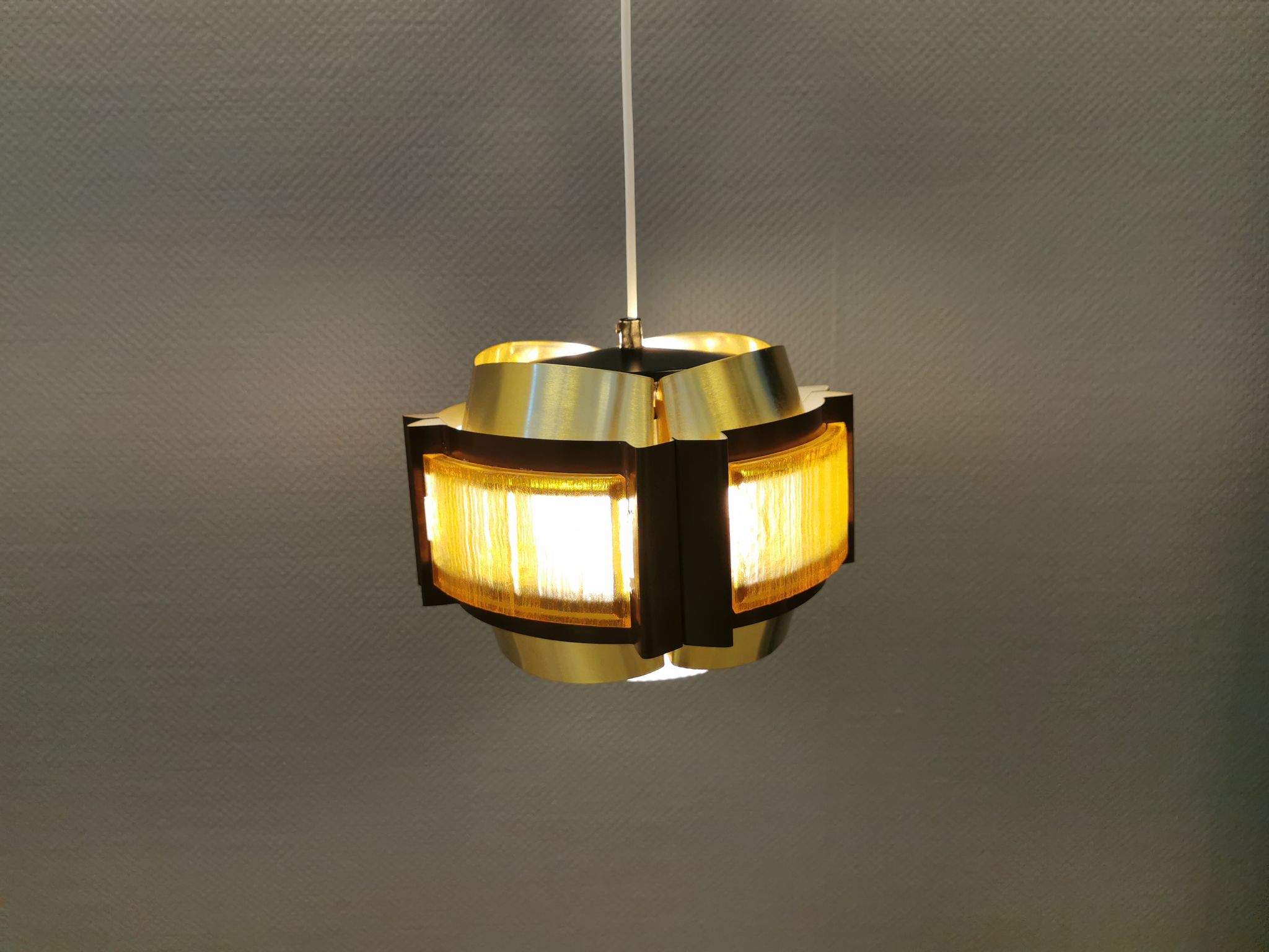 Danish hanging lamp, made in brass colored and brown metal, with yellowish hard pressed plastic deta