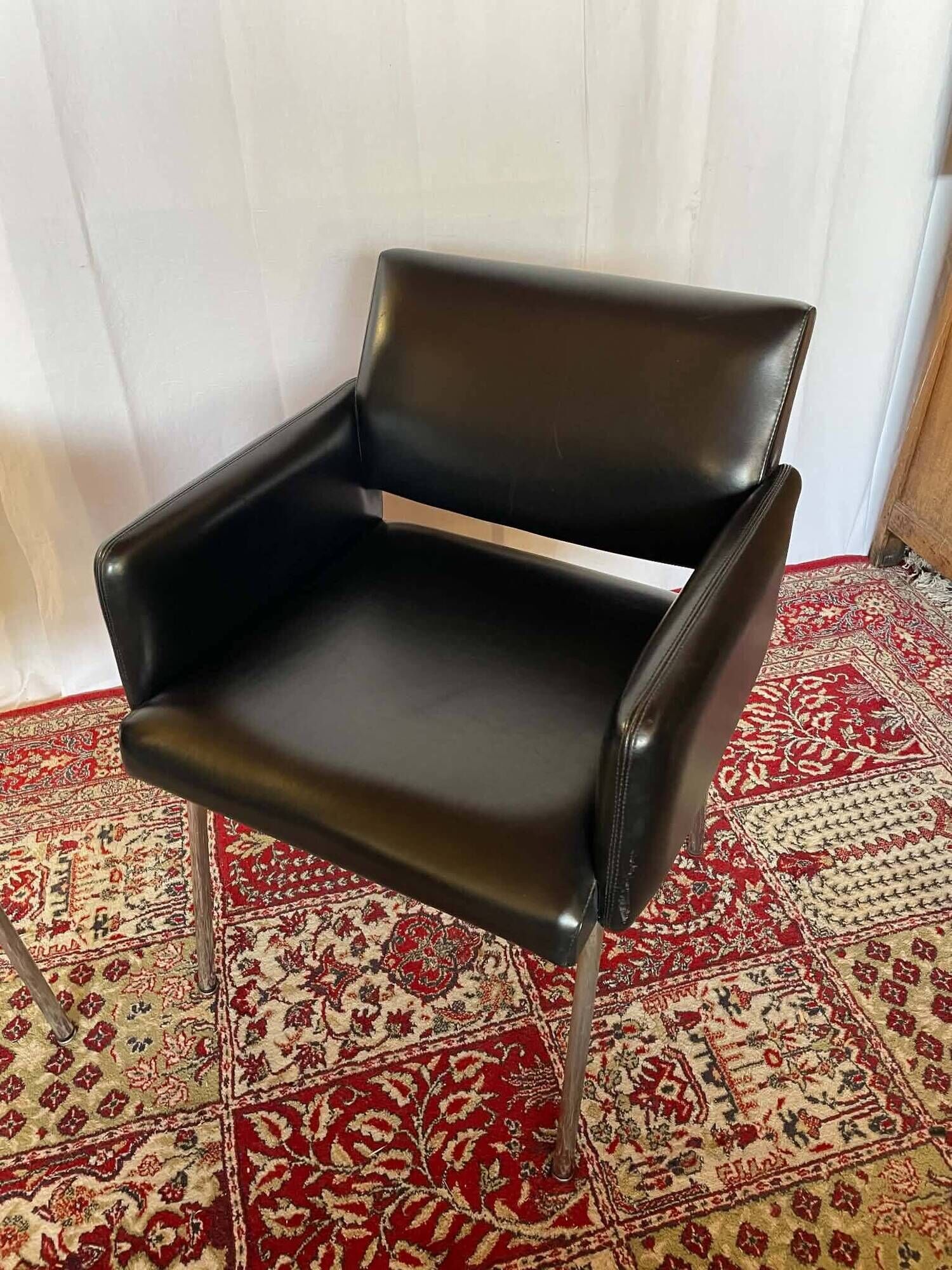 Pair of vintage armchairs in black faux leather and chrome metal.