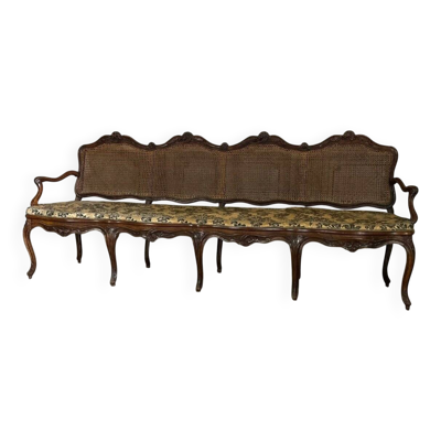 Grande banquette Louis XV en bois naturel mouluré et sculpté, France XVIIIème siècle