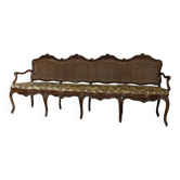 Grande banquette Louis XV en bois naturel mouluré et sculpté, France XVIIIème siècle