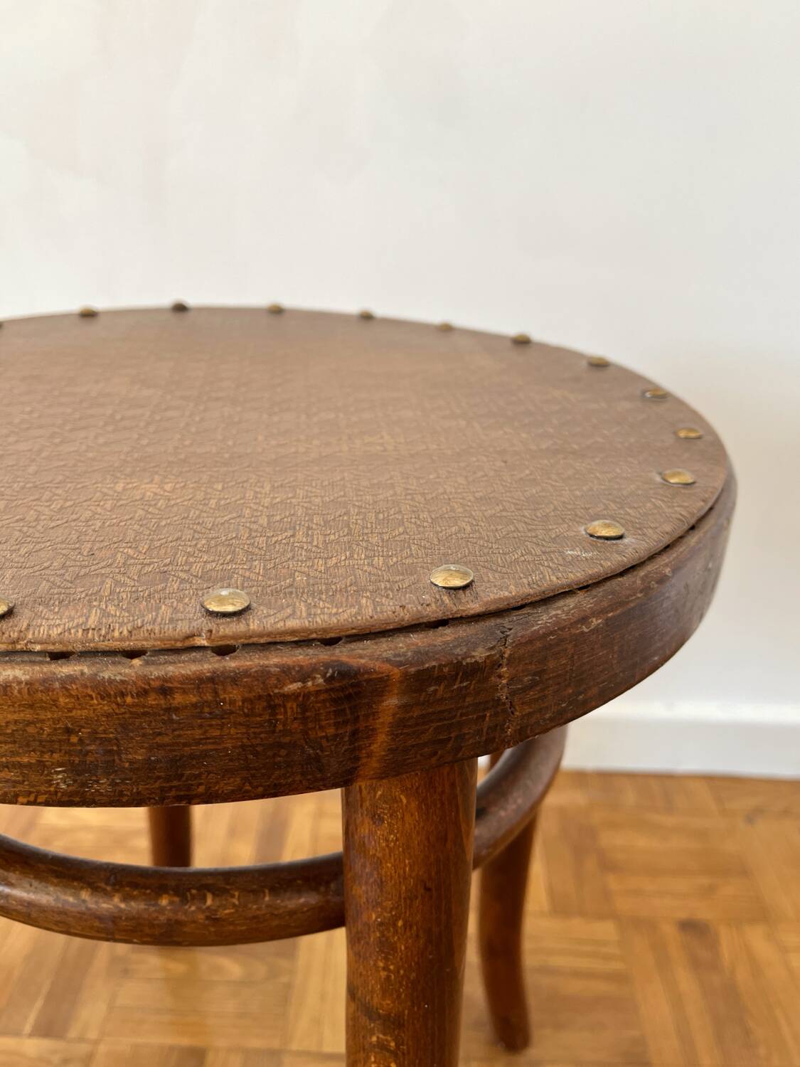 2 antique bistro stools with curved wood and caning effect.
