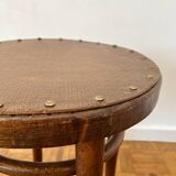 2 antique bistro stools with curved wood and caning effect.