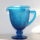 Old table set in blue pressed moulded glass