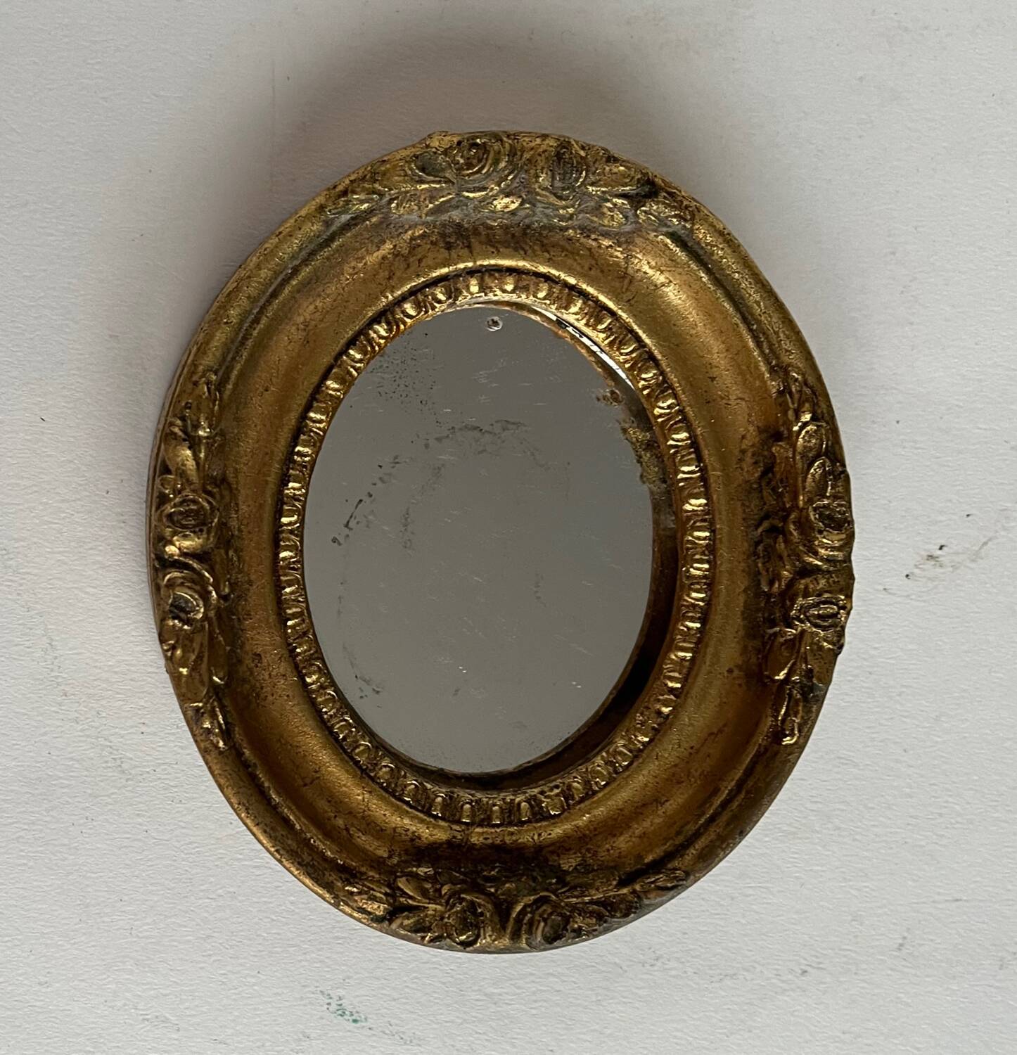 Small old mirror in gilded wood