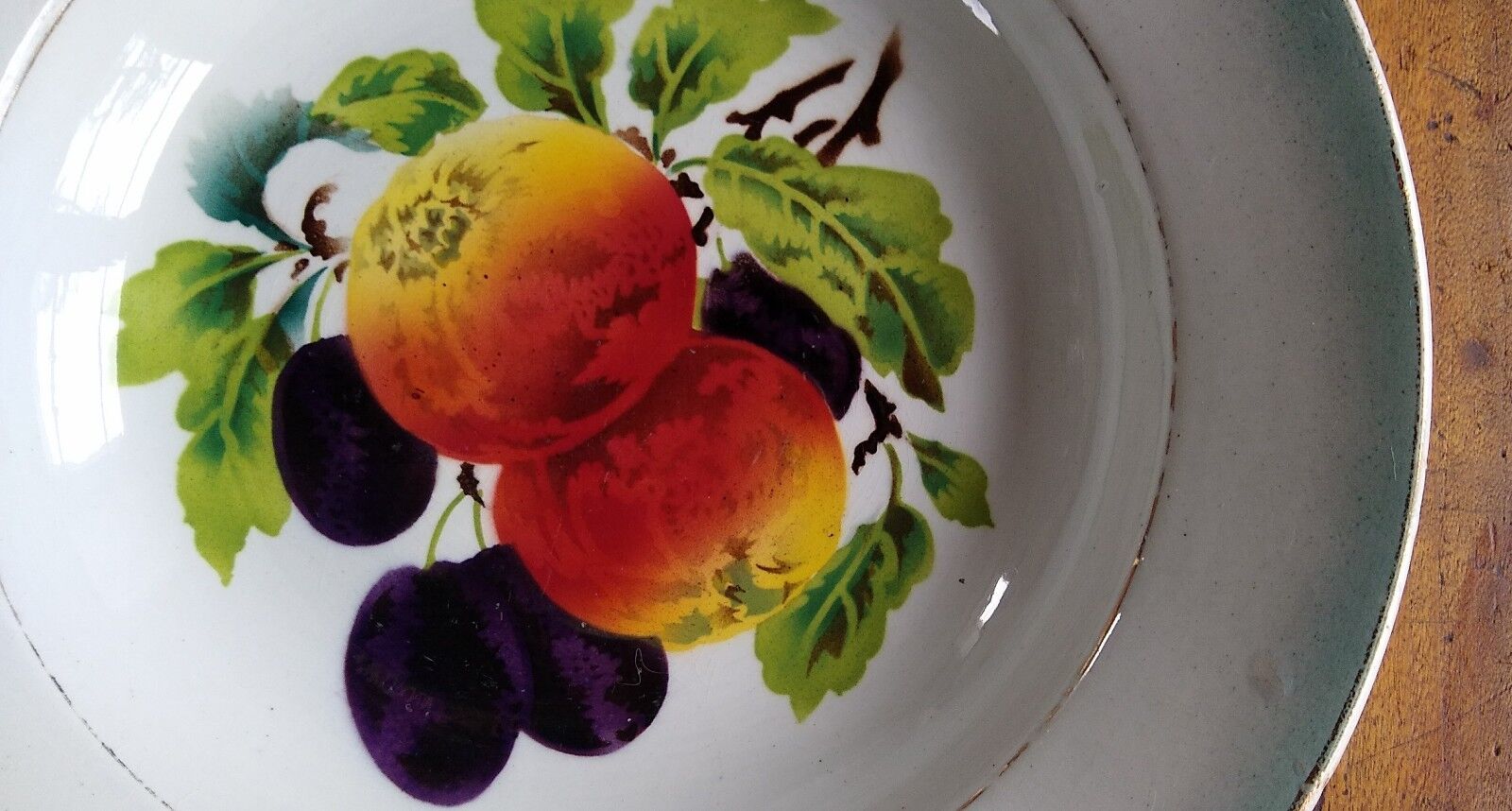 Round dish in Earthenware St Amand decorated with fruit apples and plums