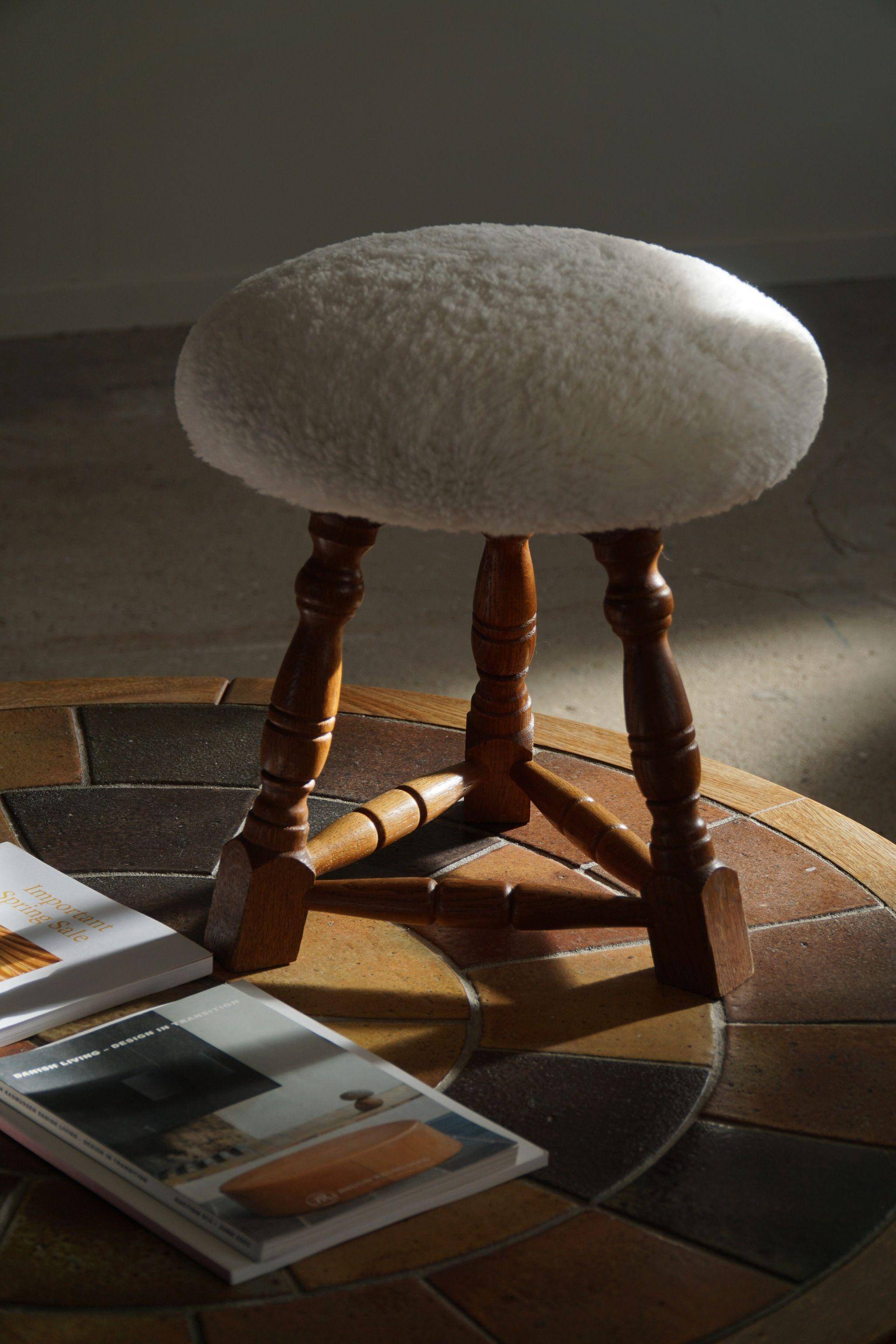 Modern Danish, a pair of tripod stools, seats reupholstered in lambswool, 1950s.