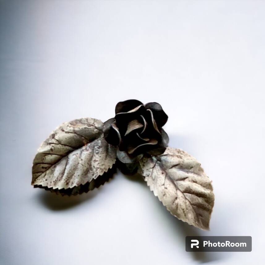 Vintage wall mirror in varnished steel decorated with a rose in relief