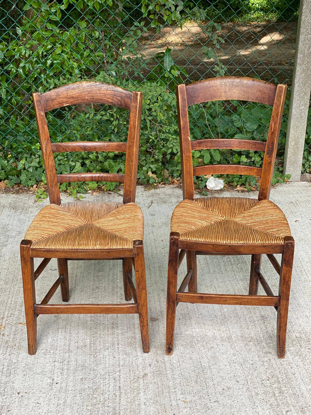 2 solid oak and straw wood chairs