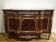 A Louis XV style sideboard with white marble top, adorned with bronze, and five drawers.