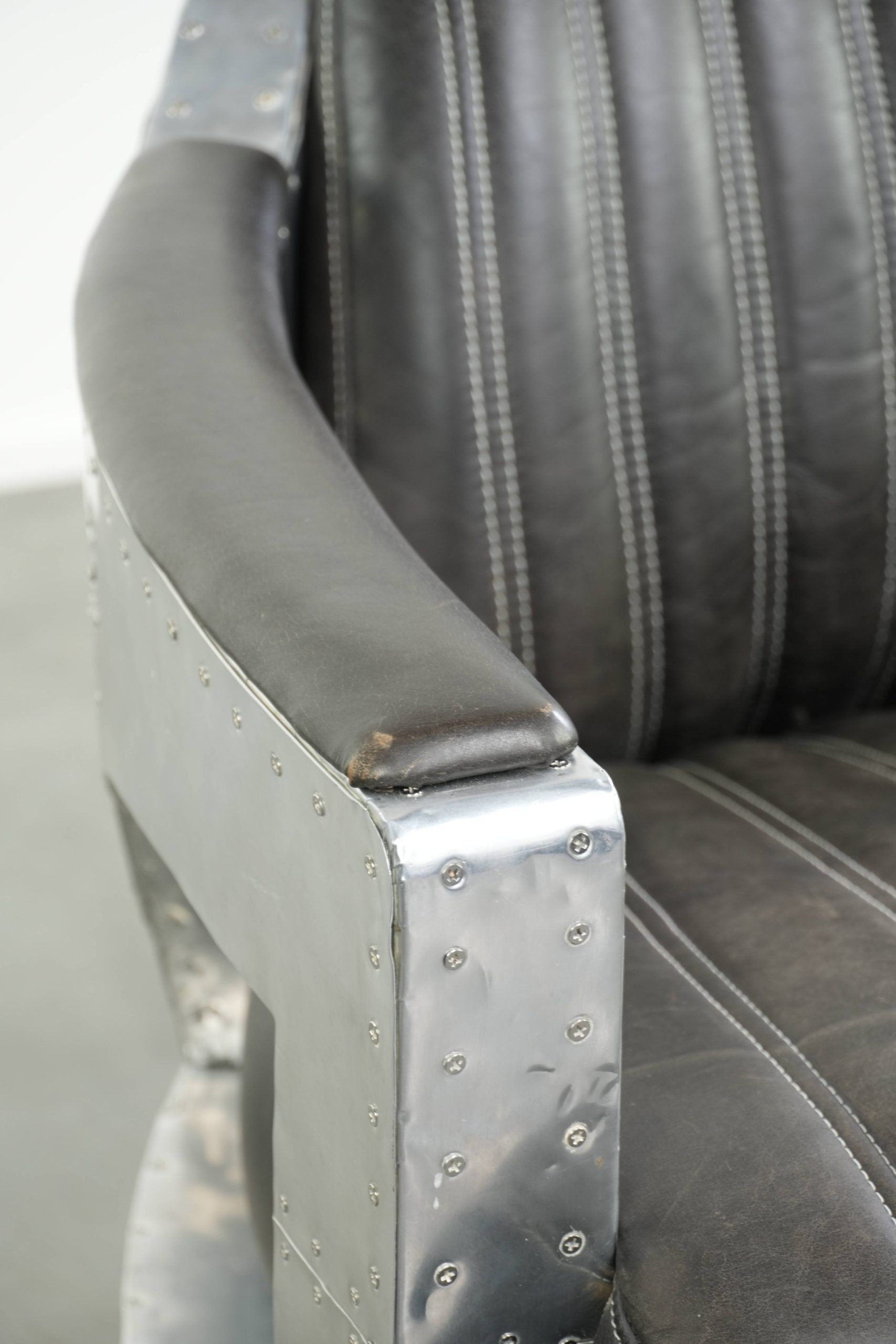 Cow leather aviator design armchair finished with aluminium and rivets