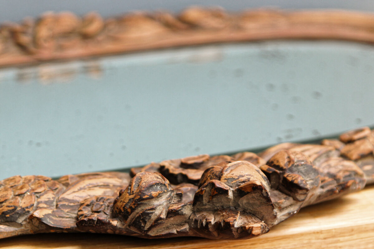 Beveled mirror in carved wood