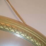 Oval mirror in wood and gilded plaster with pompom decoration