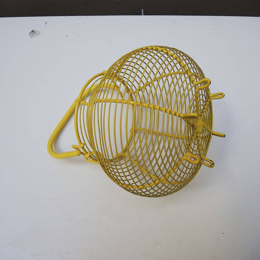 Old yellow painted metal egg basket