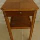 Small art deco style piece of furniture with one drawer and one shelf
