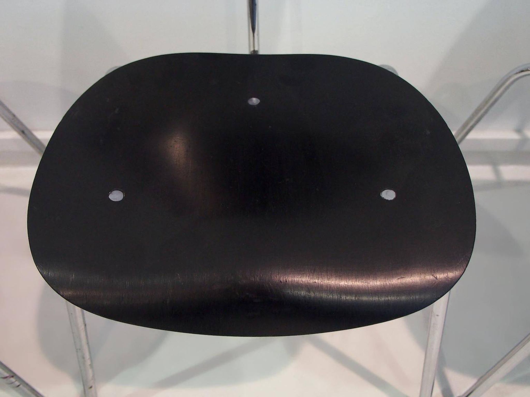 Set of four Egon Eiermann model SE 68 chairs in black lacquered plywood and steel.