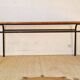 Table with tubular metal legs and wooden top.