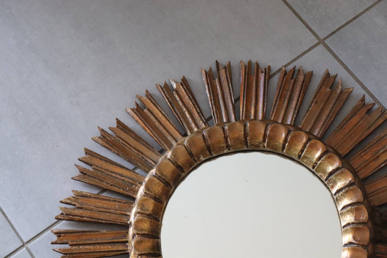 Old large sun mirror in gilded wood