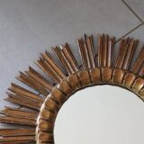 Old large sun mirror in gilded wood