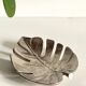 Leaf-shaped metal pocket emptier